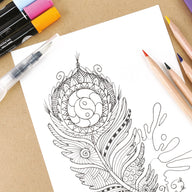 Coloring book page with intricate design and art supplies on a wooden surface