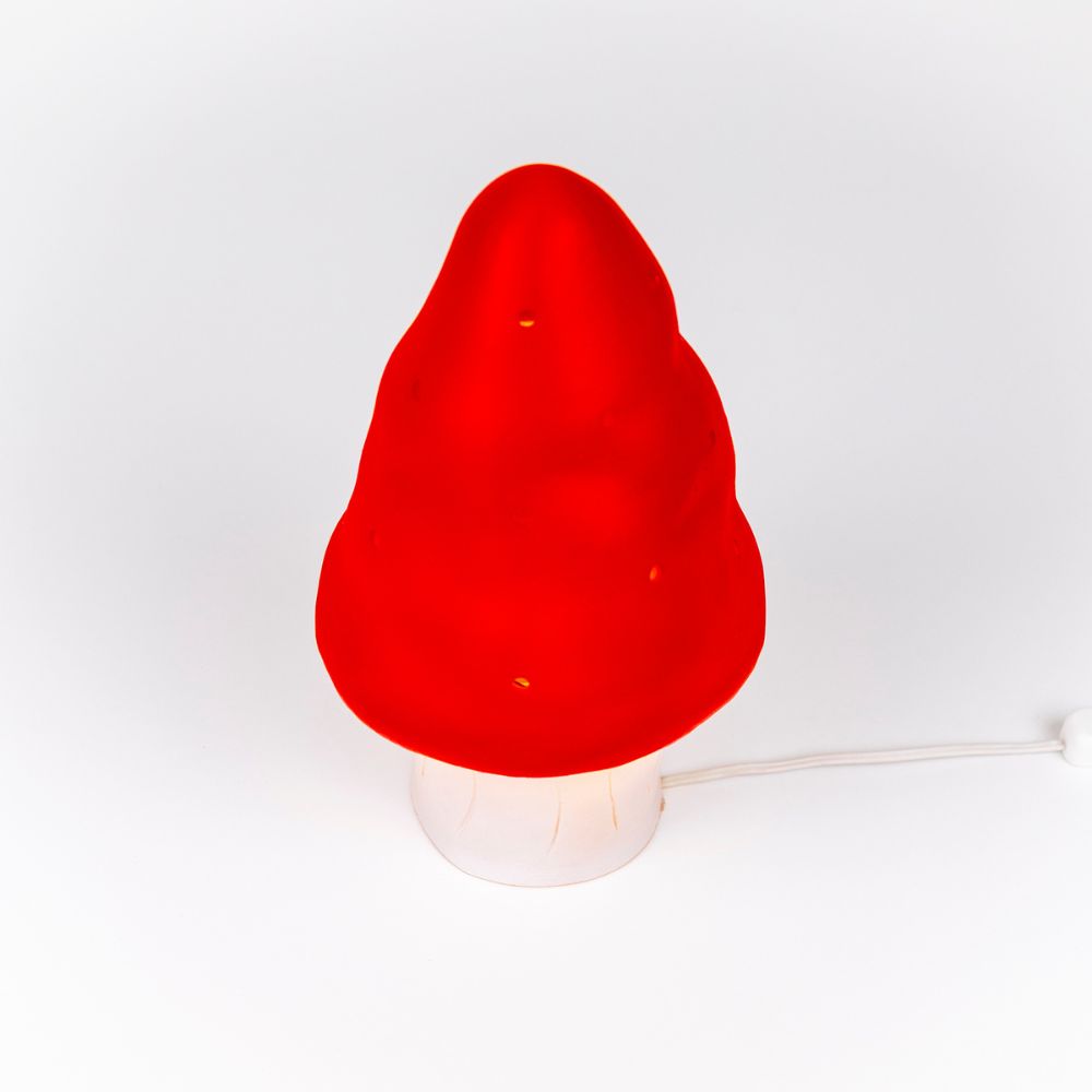 Red mushroom-shaped lamp on a white background