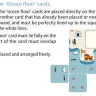 Instruction sheet showing how to arrange 'Ocean floor' cards on a table, with a small example layout and printed rules on a white background.